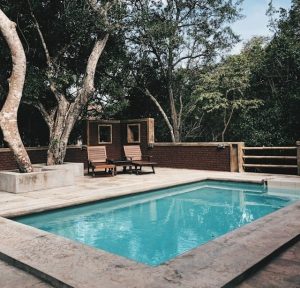 Two lounge chairs near swimming pool